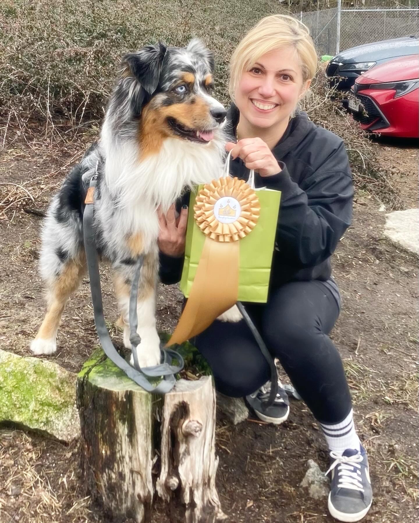 Bee Fattal with her dog and a rosette at a dog agility event